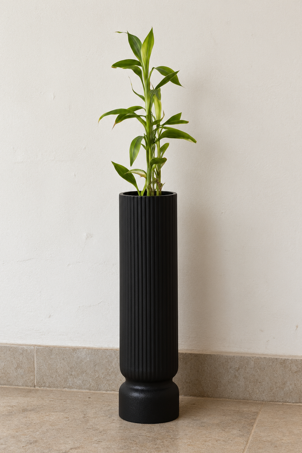 Black ribbed planter with greenery